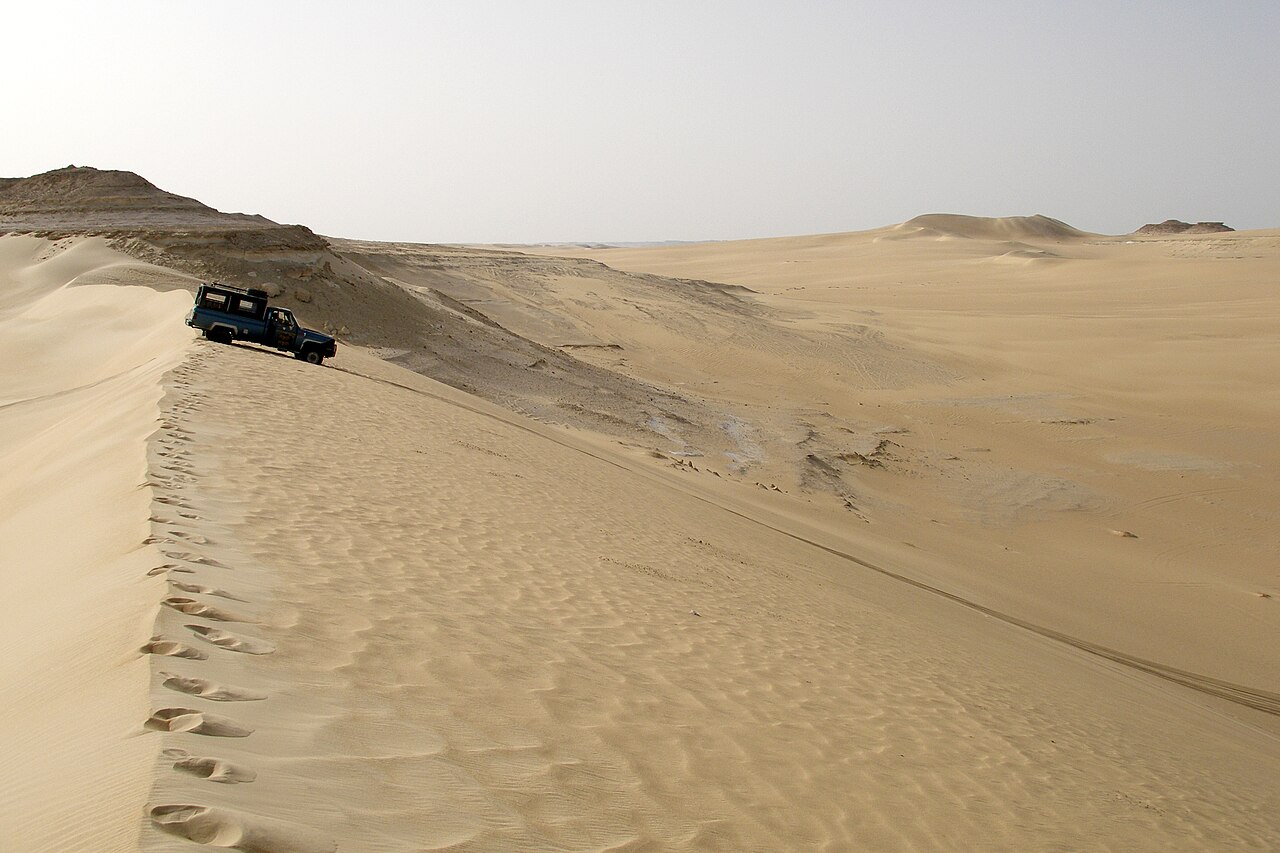 A four-wheel-drive vehicle on sand dunes near Siwa, Egypt.